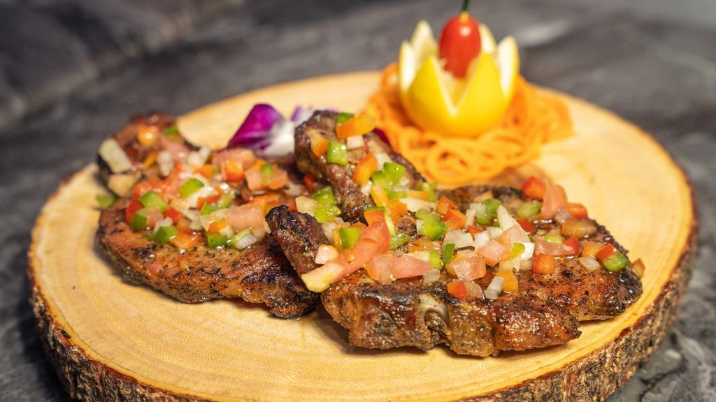 Grilled Pork Chops · 16 oz Pork chop prepared with parmesan and tomato glaze served with your choice of side.