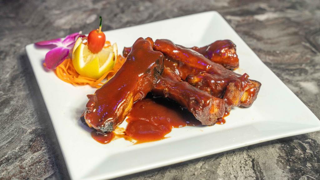 Baby Back Ribs · Finger-licking ribs smothered in BBQ sauce served with your choice of side.