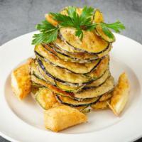 Kolokithi · Paper thin cut zucchini and eggplant served with lightly fried kefalograviera cheese and tza...