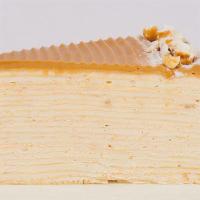 Popcorn Mille Crepe · Layers of crêpes and popcorn cream. Topped with golden caramel popcorn and blond chocolate g...