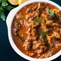 Traditional Goat Curry · Mutton sauteed in onion tomato curry and flavored with aromatic spices