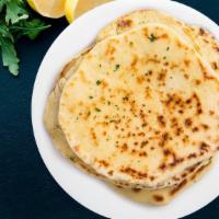 Plain Naan · Leavened flatbread made from white flour and baked in tandoor oven