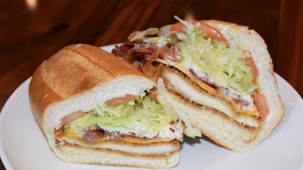 The Griswold · With breaded chicken, bacon, cheddar cheese, lettuce, tomato, ranch dressing.