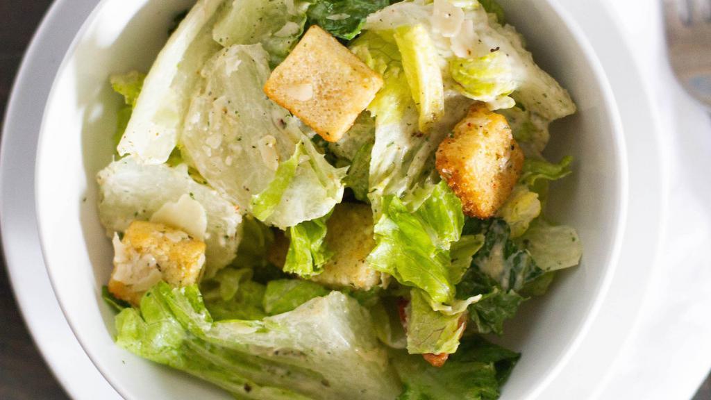 Caesar Salad · romaine lettuce, romano cheese, shaved parmesan, roasted garlic croutons and homemade caesar dressing.