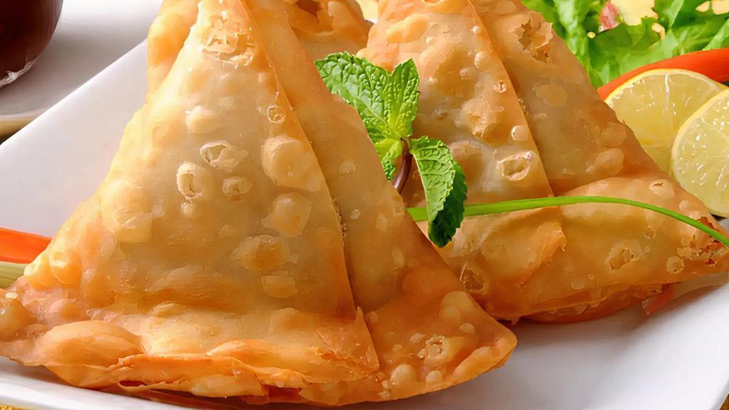 Two Keema Samosa   · Triangular patties filled with mince meat.
