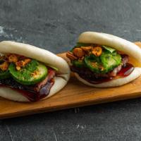 Classic Pork Belly Bao Bun . · Steamed bao buns (2 pcs) with house cured pork belly, hoisin, cucumber, plum sauce, and nuts...