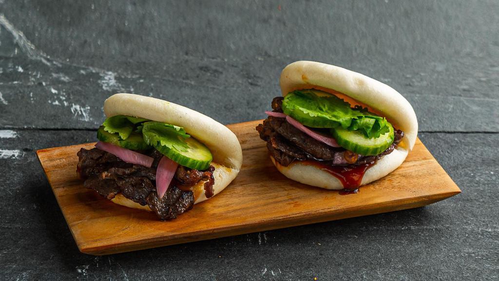 Marinated Beef Bao Bun . · Steamed bao buns (2 pcs) with marinated beef, pickled red onion, cucumber, hoisin, and cilantro.
Contains: Gluten, Soy