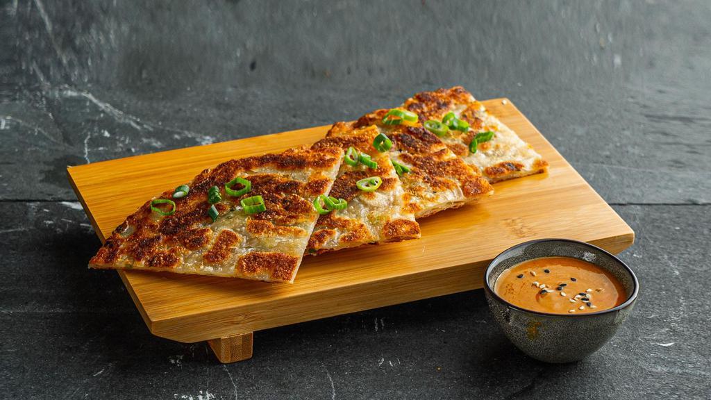 Scallion Pancakes . · Pan fried Chinese savory flat bread folded with scallions.
Served with yellow curry sauce.
Contains: Tree Nuts, Gluten, Eggs, Soy