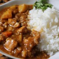 Chicken Curry Rice · Japanese curry sauce with chicken carrots and onions then poured over rice.