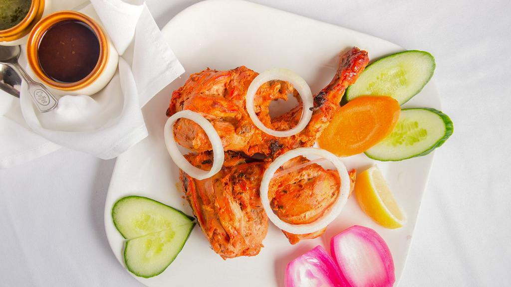 Tandoori Chicken · Half chicken marinated with yogurt and spices. The tastiest way to barbeque chicken. Served with basmati rice pulao.