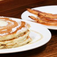 Griddle With Bacon · Topped with butter & dusting of powder sugar.
Syrup on side.
