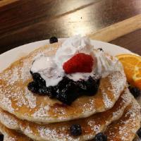 Blueberry Madness · Pancakes with juicy blueberries, topped with a dollop of glazed blueberries and cream. Serve...