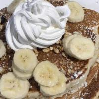 Granola & Banana Stack · Fluffy pancakes cooked with crispy granola and topped with banana slices, dusting of powder ...