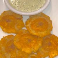 Tostones · Fried green plantains.
Served wit mojito dipping sauce.