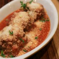 Meatballs Pomodoro · 3 home-made meatballs with tomato sauce topped with fresh basil and Parmesan cheese.