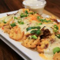 Ssd Nachos · Crispy waffle fries topped with beef chili, melted jack, and cheddar cheese, topped with sou...