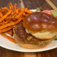 Salmon Burger Deluxe · Flaked salmon patty blended with herbs and spices. Served on a brioche bun with lettuce, tom...