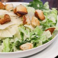 Caesar Salad · Romaine lettuce, shaved parmesan cheese, and croutons tossed in caesar dressing. Vegetarian.