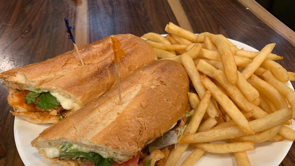 The Buffalo Bill Sandwich · Grilled buffalo chicken breast with bacon and Provolone on a toasted hero with lettuce, tomato, and blue cheese sauce. Served with fries.