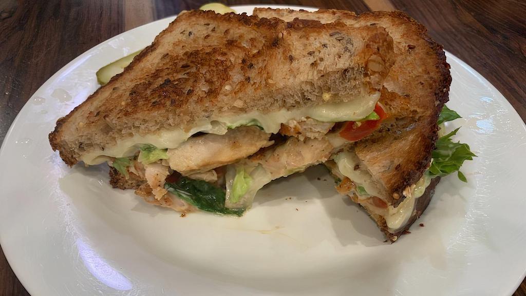 Florence Panini · Grilled chicken topped with roasted sweet peppers, melted Mozzarella, pesto mayo, and greens. Served on rustic panini bread.