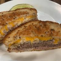 The Western Panini · Hot roast beef with caramelized onions, melted Cheddar, and horseradish mayo. Served on mult...