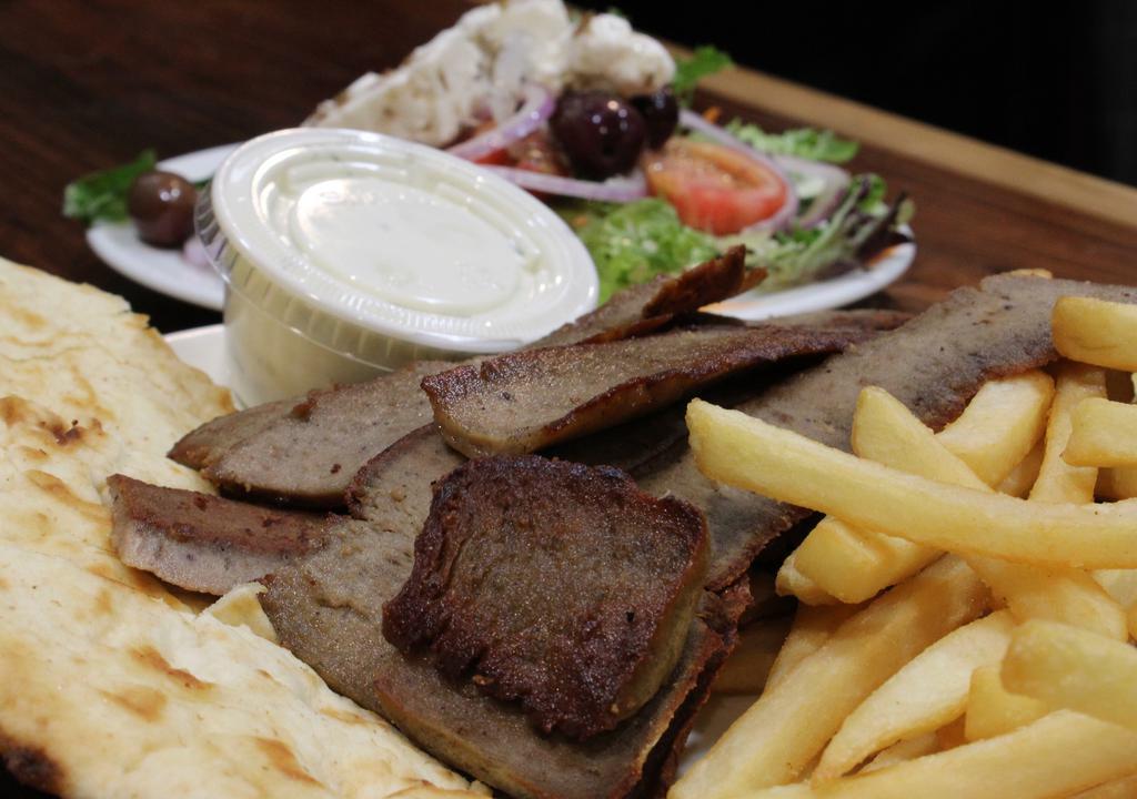 Gyro Dinner · Gyro meat served with a Greek salad, fries and pita bread.