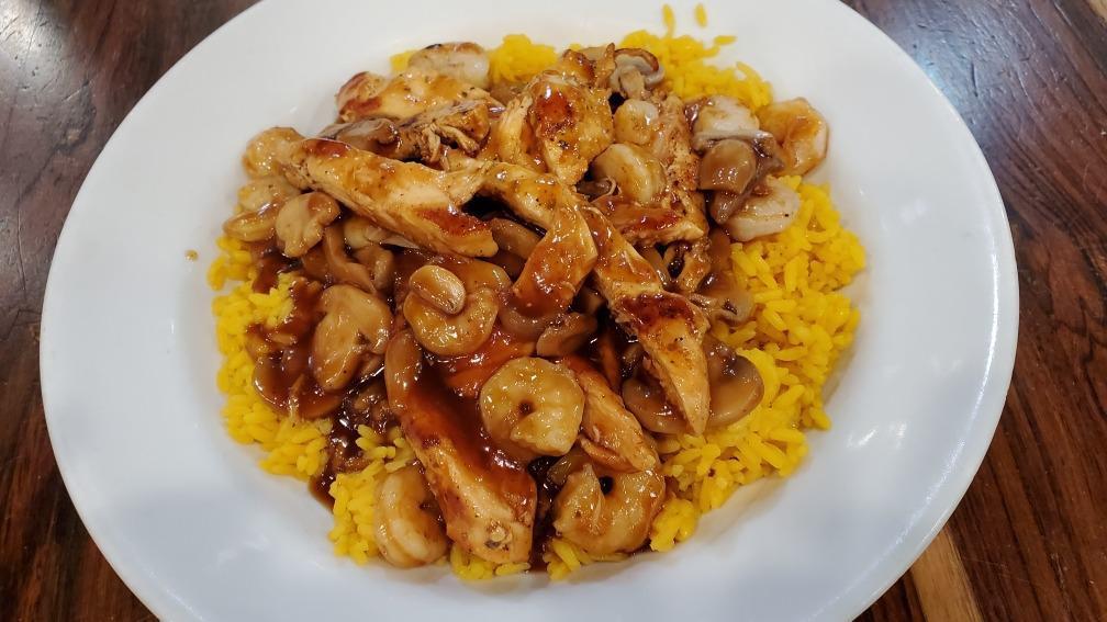 Teriyaki Chicken And Shrimp · Teriyaki chicken and shrimp served with mushrooms over yellow rice.