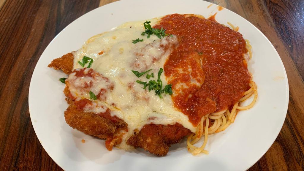 Chicken Parmigiana · Tender breaded chicken breasts topped with marinara sauce served with spaghetti and topped with mozzarella. Baked to golden brown perfection.