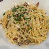 Spaghetti Carbonara · Bacon, parmesan cheese in a light cream sauce. SERVED W/ SALAD & BREAD.