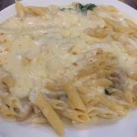 Creamy Mushroom & Spinach Pasta · Penne pasta tossed with spinach, mushrooms, and garlic in a light wine cream sauce topped wi...