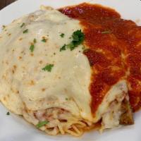 Veal Parmigiana · Breaded veal cutlets topped with marinara sauce. Served with spaghetti and topped with mozza...