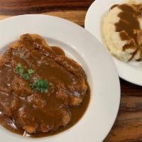 Country-Fried Steak Dinner · A breaded and golden-fried beef steak topped with gravy.