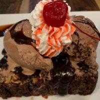 Hot Fudge Brownie Sundae · On top of a fresh baked chocolate brownie with chocolate syrup, whipped cream and a cherry.