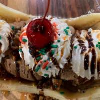 Original Banana Split · On top of a sliced banana with choice of topping, whipped cream, nuts and a cherry.
