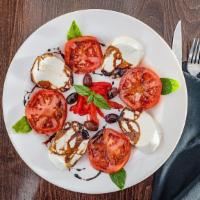 Caprese Salad · Sliced Fresh mozzarella, sliced Jersey tomato, salt pep, roasted peppers and olives, drizzle...