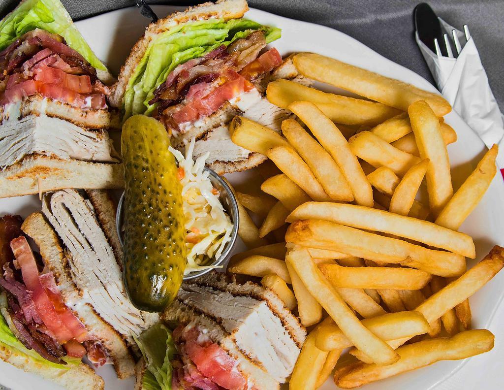 Roast Turkey Club · Prepared on three slices of bread with bacon, lettuce, tomato, and mayonnaise. Served with French fries.