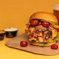 Juicy Lucy Burger · Seared Pat Lafrieda patty stuffed with American cheese topped with crispy bacon, lettuce, on...