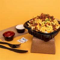 Bacon Cheese Fries · Crispy hand cut fries with our homemade cheese sauce topped with a crispy bacon crumble.