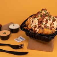 Crack Tots · Crispy tater tots with our Crack Sauce, bacon crumble, and chives.
