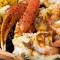 Snow Crab Legs W/ Shrimp & Potatoes And Corn Bag · .comes with potatoes corn & Cajun  sauce