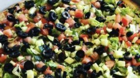 Salad Pizza · Mixed greens, carrots, tomatoes, cucumbers, and black olives drizzled with olive oil.