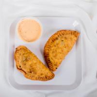 Beef Empanadas  · Deep Fried Empanadas Filled With Seasoned Ground Beef, Jalapenos and Cheddar Cheese Served W...