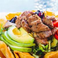 Taco Cobb Salad · Steak, spring mix, avocado, tomatoes, corn, black olives, cheddar cheese, and spiced bleu ch...