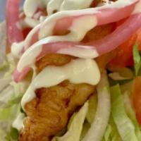 Beer-Battered Fish Taco · with shredded lettuce, tomatoes, pickled red onions, & avocado wasabi. served on a soft flou...