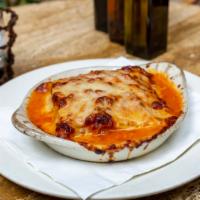 Lasagna Bolognese · Homemade pasta layered with tomato meat sauce, bechamel and parmigiano cheese.
