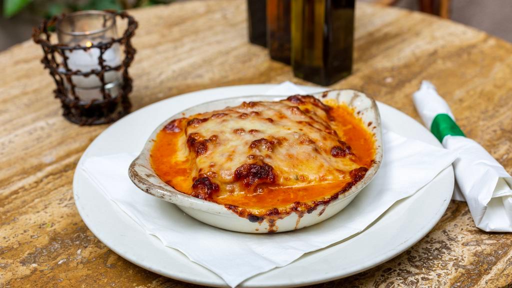 Lasagna Bolognese · Homemade pasta layered with tomato meat sauce, bechamel and parmigiano cheese.