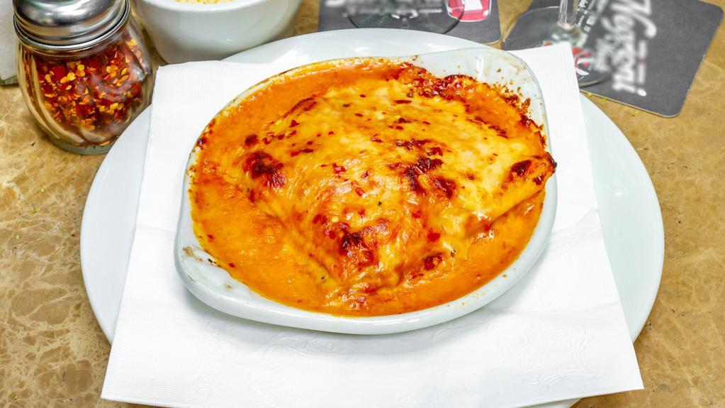 Lasagna Arrabbiata · Homemade pasta layered with spicy arrabbiata sauce, bechamel, parmigiano and mozzarella cheese