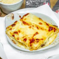 Lasagna Ai Funghi · Homemade pasta layered with sauteed mushrooms, bechamel, parmigiano and fontina cheeses