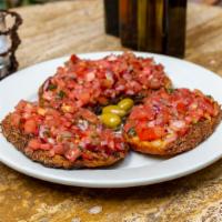 Bruschetta Pomodoro E Basilico · Grilled peasant bread, topped with tomato, basil, red onions and extra virgin olive oil.