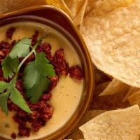 Queso · Three cheese blend, roasted tomato, pickled jalapeño. Served with warm corn tortilla chips. ...